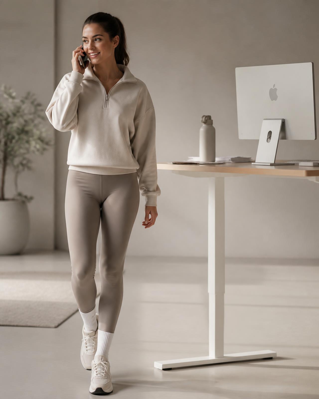 Person taking a walking phone call beside a standing desk